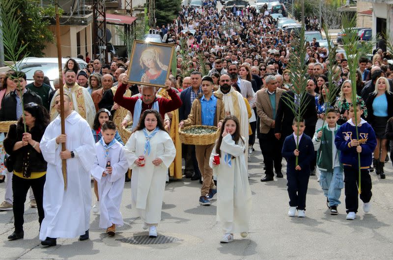 Lebanese Christian worshippers take part in a Palm Sunday procession in Klayaa