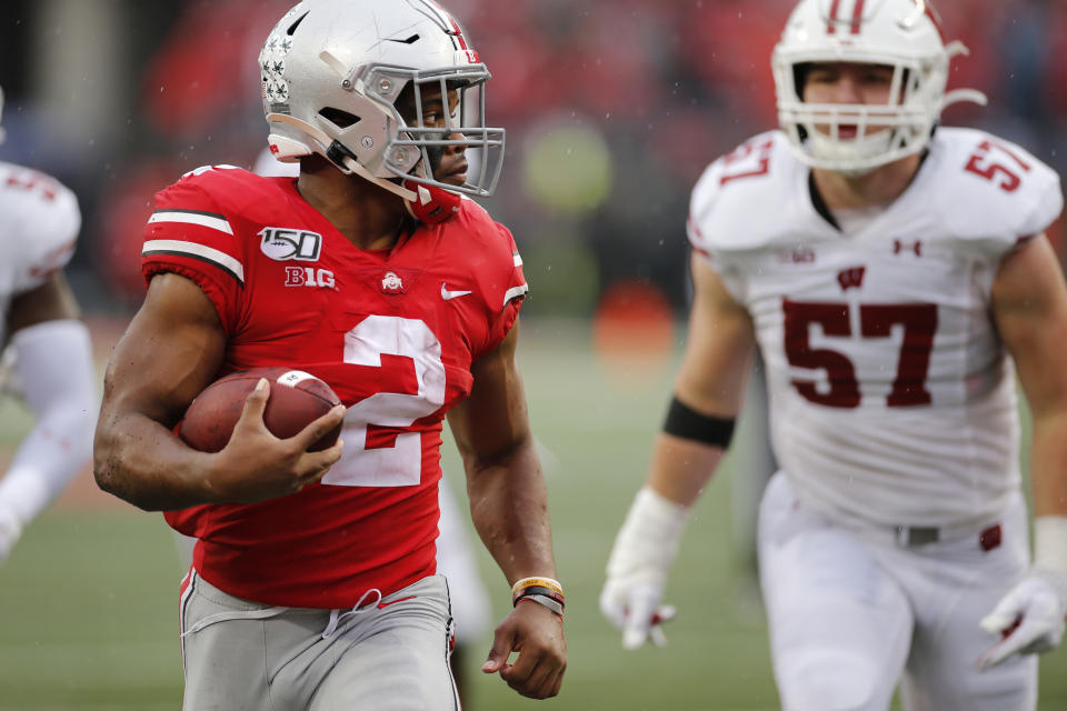 Ohio State running back J.K. Dobbins, left, outruns the Wisconsin defense for a touchdown during the second half of an NCAA college football game Saturday, Oct. 26, 2019, in Columbus, Ohio. Ohio State beat Wisconsin 38-7. (AP Photo/Jay LaPrete)