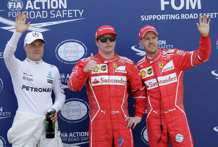 Formula One - F1 - Monaco Grand Prix - Monaco - 27/05/2017 - Ferrari's Kimi Raikkonen, Mercedes' Valtteri Bottas (L) and Ferrari's Sebastian Vettel wave after setting the pole position in qualifying session. REUTERS/Max Rossi