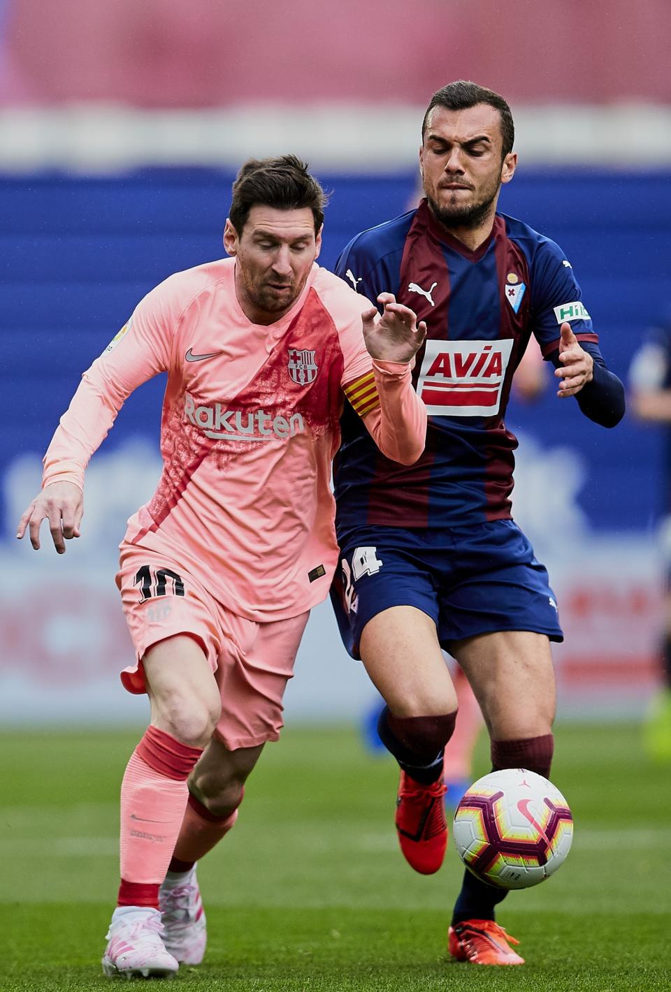Barcelona's Lionel Messi, left, duels for the ball against Eibar's Joan Jordan during a Spanish La Liga soccer match at the Ipurua stadium, in Eibar, northern Spain, Sunday, May 19, 2019. (AP Photo/Ion Alcoba)