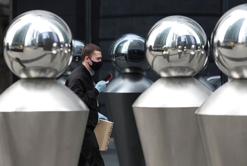 A man wearing a protective mask and gloves walks in a street amid the outbreak of the coronavirus disease in Moscow