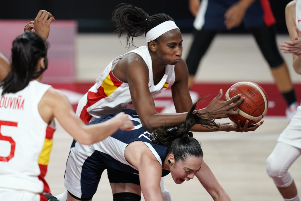 Spain's Astou Ndour, top, grabs a rebound over France's Sarah Michel (10) during a women's basketball quarterfinal round game at the 2020 Summer Olympics, Wednesday, Aug. 4, 2021, in Saitama, Japan. (AP Photo/Charlie Neibergall)