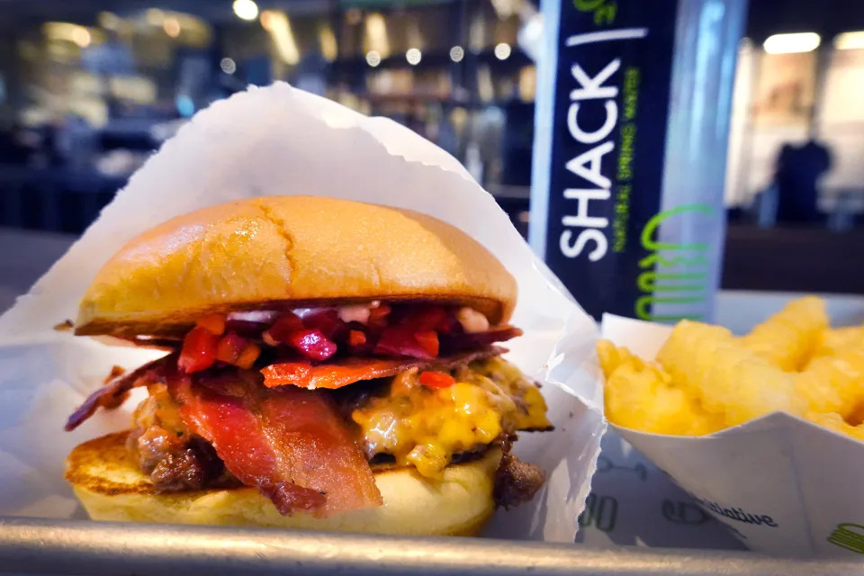 CHICAGO, ILLINOIS - MAY 06:  In this photo illustration a bacon cheeseburger sandwich and fries are served at a Shake Shack restaurant on May 06, 2022 in Chicago, Illinois. (Photo Illustration by Scott Olson/Getty Images)