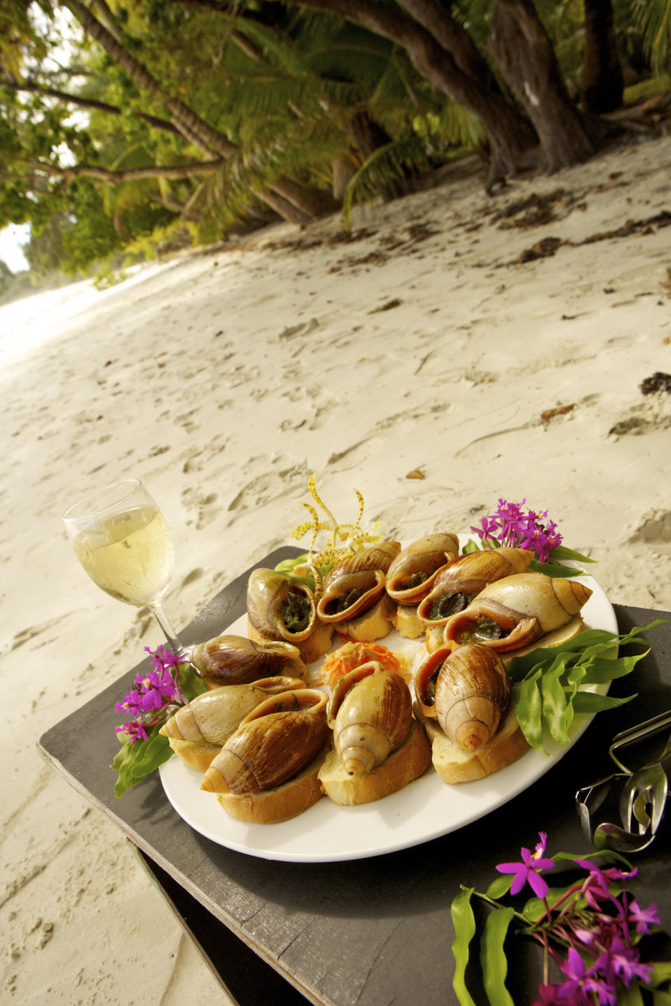 The famous Isle of Pines snails on the beach at Hotel Kou-Bugny. And don’t forget the Pinot Gris! Photo: Getty