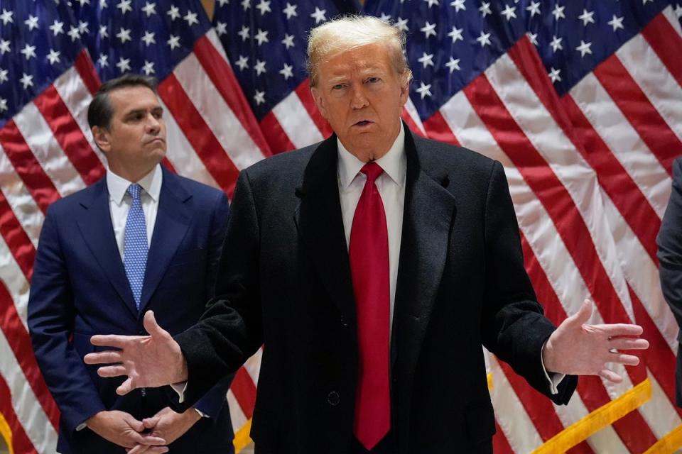 Donald Trump speaks to reporters from 40 Wall Street on 25 March. (AP)