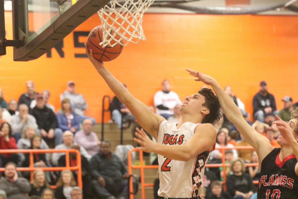 Lucas' Logan Toms finished a layup at the rim during the Cubs' win over Mansfield Christian on Friday night.