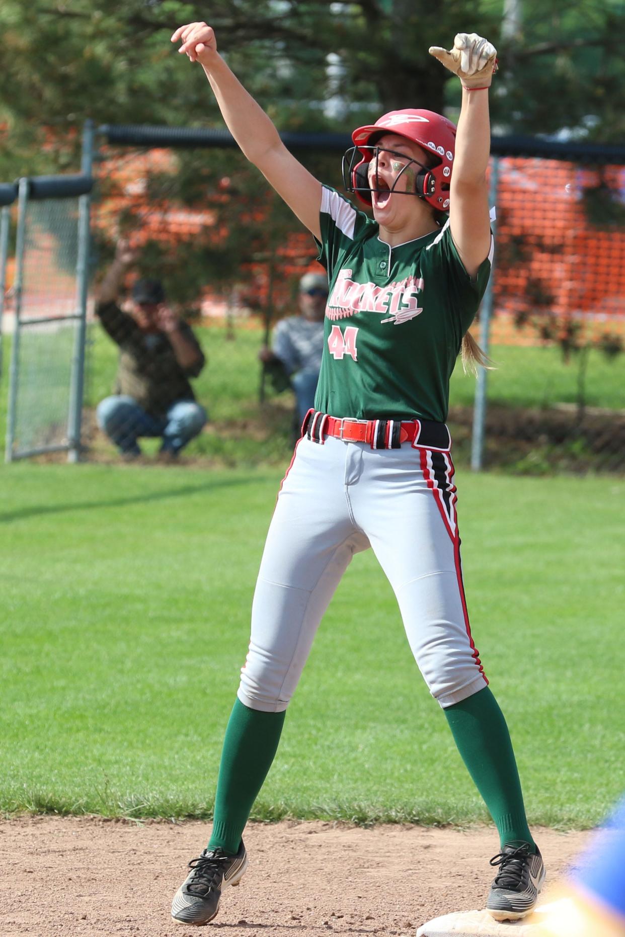 Oak Harbor's Sydney Overmyer celebrates her triple in the fourth inning.