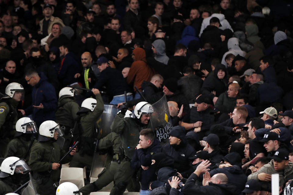 Greek riot police clash with Ajax fans before the start of a Group E Champions League soccer match between AEK Athens and Ajax at the Olympic Stadium in Athens, Tuesday, Nov. 27, 2018. (AP Photo/Thanassis Stavrakis)