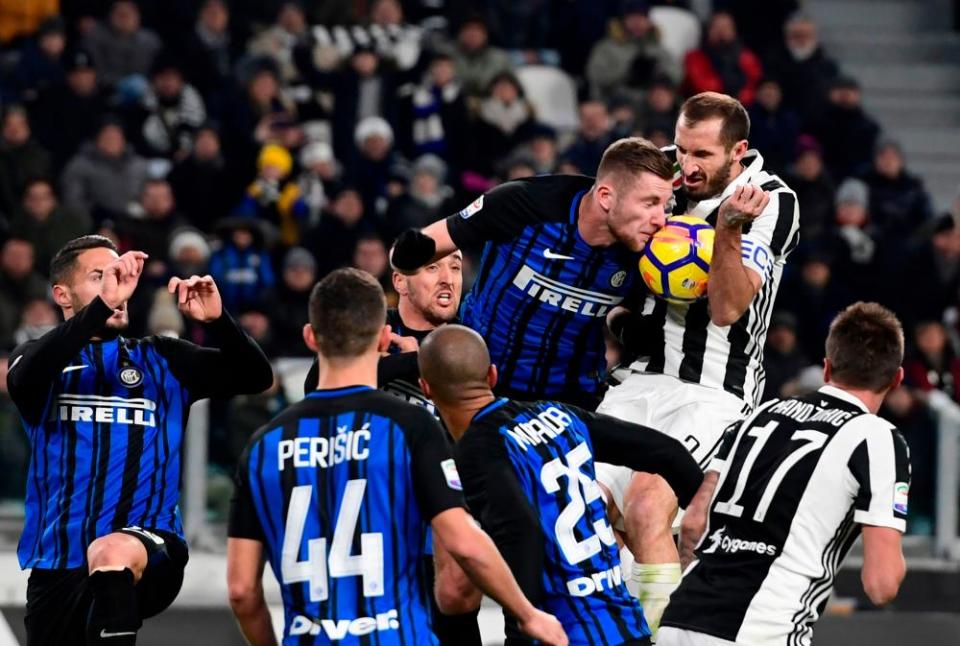 Giorgio Chiellini fights for the ball with Inter defender Milan Skriniar.