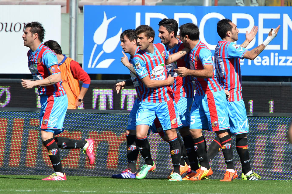 Catania's Mariano Izco, left, celebrates with his teammates after scoring during the Serie A soccer match between Catania and Lazio at the Angelo Massimino stadium in Catania, Italy, Sunday, Feb. 16, 2014. (AP Photo/Carmelo Imbesi)