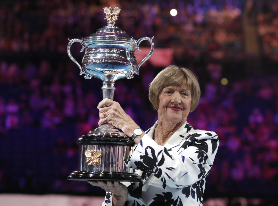 FILE - In this Jan. 27, 2020, file photo, former Australian Open champion Margaret Court holds up the women's Australian Open trophy, the Daphne Ackhurst Memorial Cup, as her 50th anniversary of her Grand Slam is celebrated at the Australian Open tennis championship in Melbourne, Australia. Australia media are reporting that controversial former tennis champion Margaret Court will receive the country’s top award in the Australia Day honors list, and the apparent decision is already being criticized. The 78-year-old’s appointment as Companion of the Order of Australia was reported to be revealed late on Monday, Jan. 26, 2021, but it was leaked on social media. (AP Photo/Lee Jin-man, File)