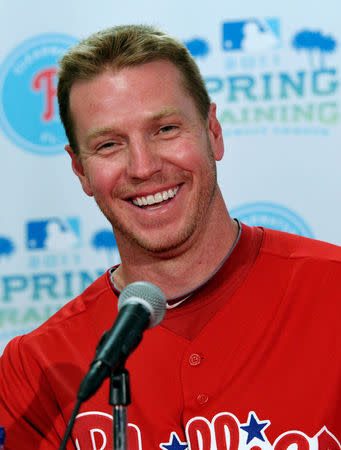 FILE PHOTO: Philadelphia Phillies starting pitcher Roy Halladay laughs during a news conference at their MLB National League spring training facility in Clearwater, Florida, U.S., February 14, 2011. REUTERS/Mike Cassese/File Photo