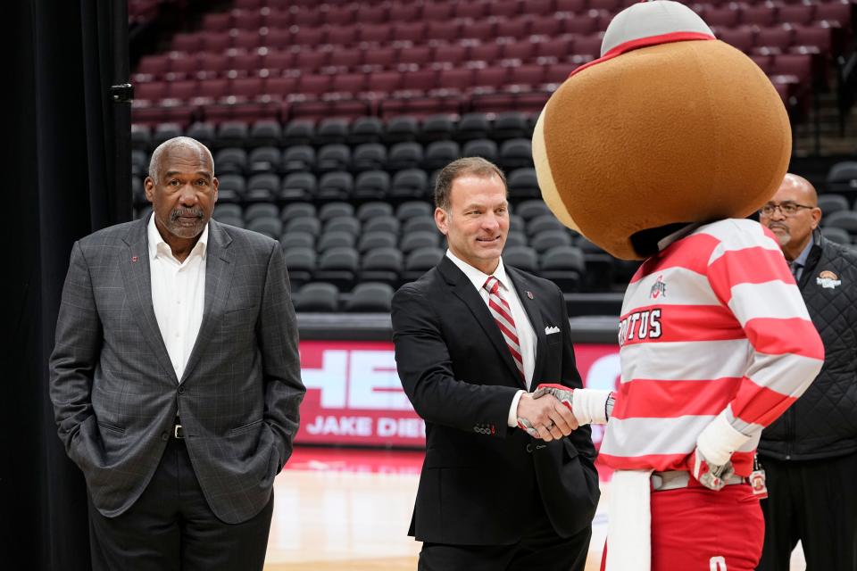 As Ohio State's new athletic director, Ross Bjork, center, will oversee revenue sharing with Buckeyes athletes, should a federal judge OK an NCAA proposal.