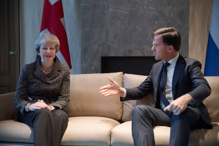 British Prime Minister Theresa May and Dutch Prime Minister Mark Rutte pose for photographers at the start of a meeting in the Hague, the Netherlands December 11, 2018. Peter Dejong/Pool via REUTERS