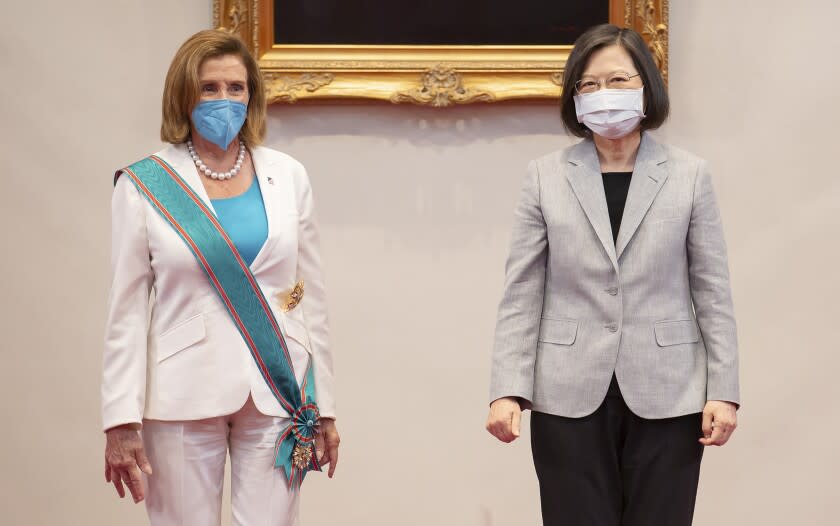 In this photo released by the Taiwan Presidential Office, U.S. House Speaker Nancy Pelosi, left, and Taiwanese President President Tsai Ing-wen stand during a meeting in Taipei, Taiwan, Wednesday, Aug. 3, 2022. U.S. House Speaker Nancy Pelosi, meeting top officials in Taiwan despite warnings from China, said Wednesday that she and other congressional leaders in a visiting delegation are showing they will not abandon their commitment to the self-governing island. (Taiwan Presidential Office via AP)