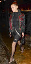 <p>The model donned an all-black ensemble, featuring black jean shorts over fishnet tights and a high-neck bodysuit worn under a hooded bomber with red embroidered details. Large hoops, strappy black heels, and a mini backpack finished off the look.</p>