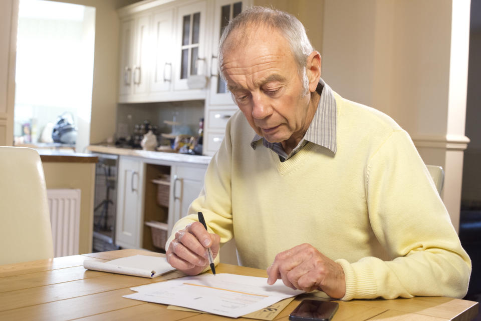 senior male with paperwork