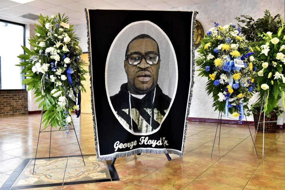 A picture of George Floyd and flowers are set up for a memorial service for Floyd, Saturday, June 6, 2020, in Raeford, N.C. Floyd died after being restrained by Minneapolis police officers on May 25. (Ed Clemente/The Fayetteville Observer via AP, Pool)