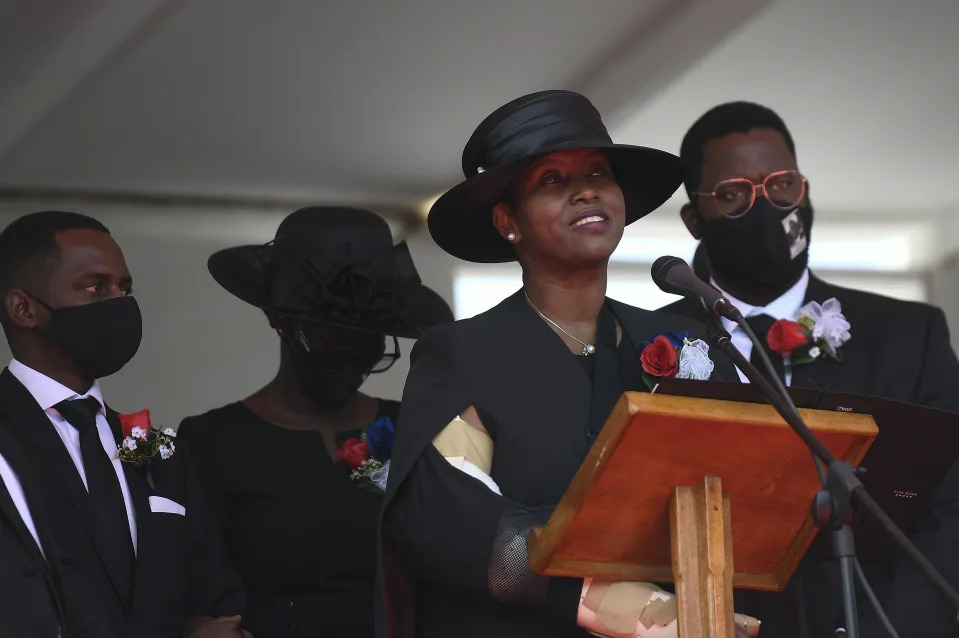 FILE - Former first lady of Haiti, Martine Moise, speaks during the funeral of her slain husband, former President Jovenel Moise, accompanied by her children in Cap-Haitien, Haiti, Friday, July 23, 2021. A judge investigating the July 2021 assassination of President Moïse issued a final report on Monday, Feb. 19, 2024, that indicts his widow, Martine Moïse, ex-prime minister Claude Joseph and the former chief of Haiti’s National Police, Léon Charles, among others. (AP Photo/Matias Delacroix, File)