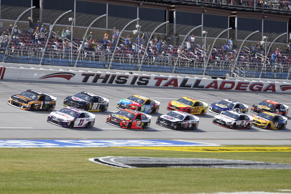 Denny Hamlin (11) and Kurt Busch (1) lead the field to the start of the YellaWood 500 NASCAR auto race at Talladega Superspeedway, Sunday, Oct. 4, 2020, in Talladega, Ala. (AP Photo/John Bazemore)