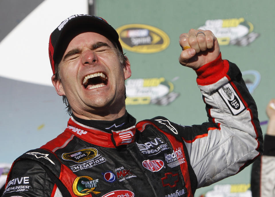 FILE - In this Feb. 27, 2011, file photo, Jeff Gordon celebrates winning the NASCAR Sprint Cup Series auto race at Phoenix International Raceway in Avondale, Ariz. Gordon headlines the 10th class of the NASCAR Hall of Fame for his storied career on and off the track. He'll be inducted on Friday night, Feb. 1,2019, along with NASCAR team owners Roger Penske and Jack Roush. (AP Photo/Ross D. Franklin, File)