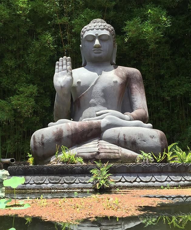 Giant statues of Buddha are scattered around esoteric hotspot, Crystal Castle. Photo: Paul Ewart