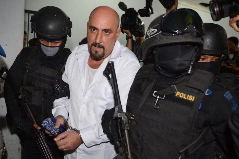 Indonesian police escort Serge Atlaoui following a court hearing in Tangerang, on March 11, 2015