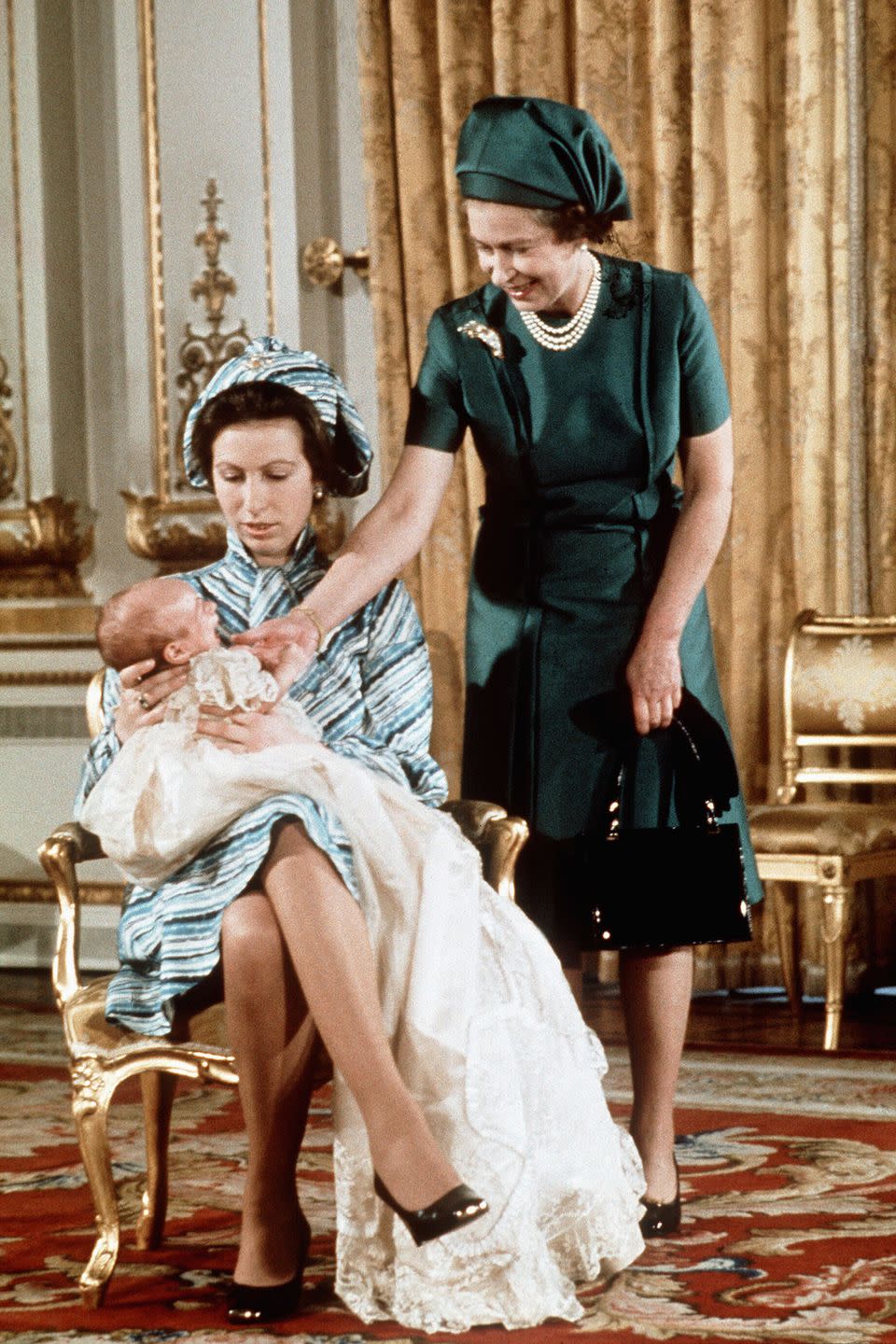 <p>Queen Elizabeth with her daughter Princess Anne and her first grandchild, Peter Phillips.</p>