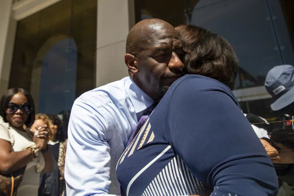 Former Tallahassee Mayor Andrew Gillum, left, and Sharon Lettman-Hicks embrace after he was found not guilty of lying to the FBI in a corruption case that also involved illegal use of campaign contributions, Thursday, May 4, 2023, in Tallahassee, Fla. (Alicia Devine/Tallahassee Democrat via AP)