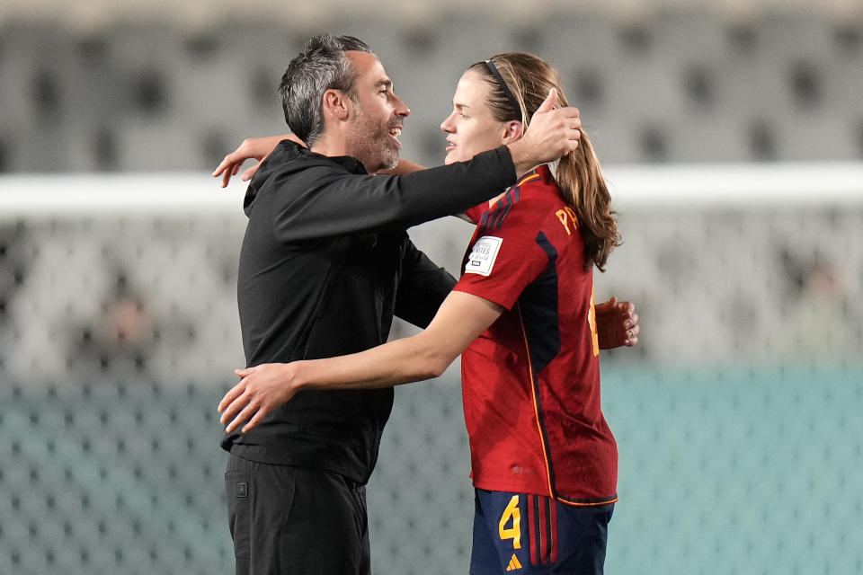 Spain's Irene Paredes is embraced by Spain's head coach Jorge Vilda after winning the Women's World Cup semifinal soccer match between Sweden and Spain at Eden Park in Auckland, New Zealand, Tuesday, Aug. 15, 2023. (AP Photo/Alessandra Tarantino)