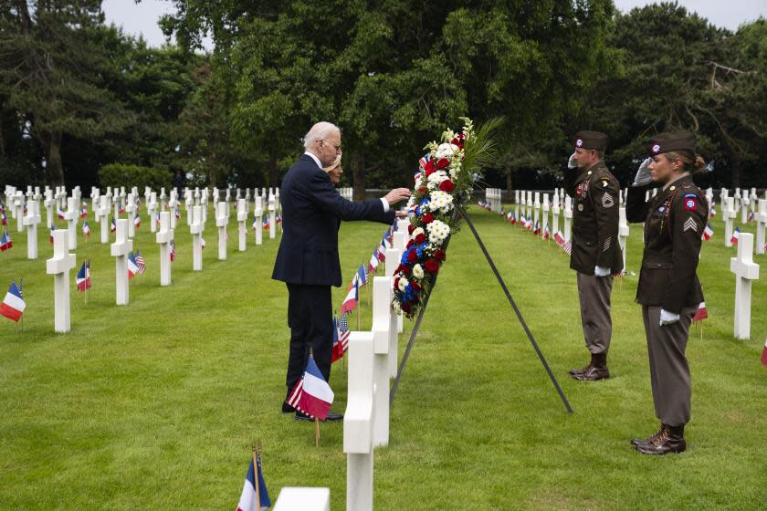 President Joe Biden and first lady Jill Biden lay a wreath in the Normandy American Cemetery following a ceremony to mark the 80th anniversary of D-Day, Thursday, June 6, 2024, in Normandy. (AP Photo/Evan Vucci)