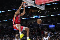 New Orleans Pelicans guard Trey Murphy III (25) slam dunks in the second half of an NBA basketball play-in tournament game against the Sacramento Kings in New Orleans, Friday, April 19, 2024. The Pelicans won 105-98. (AP Photo/Gerald Herbert)