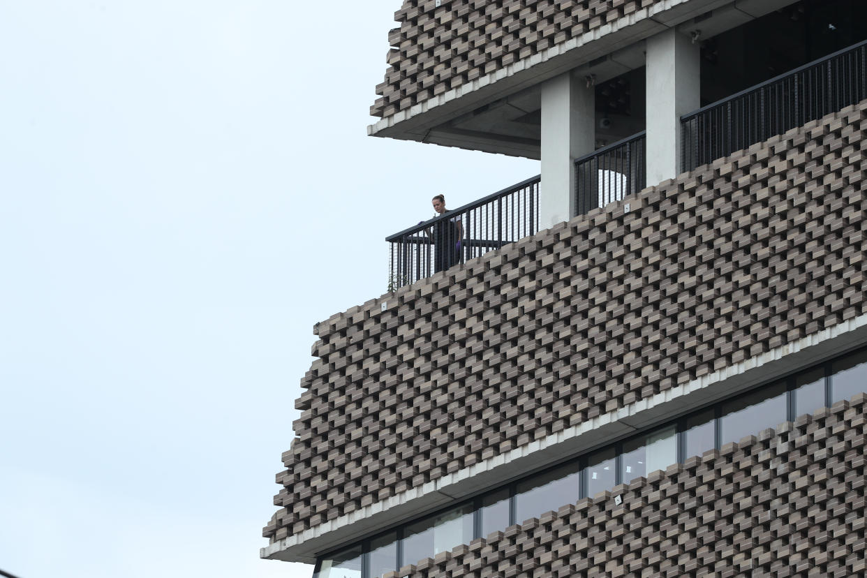 A police officer looks out from the viewing platform at the Tate Modern art gallery, following the arrest of a 17-year-old male on suspicion of attempted murder after a six-year-old boy was thrown from the tenth floor viewing platform.