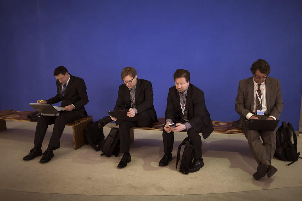 Attendees use their devices during the inauguration of the Mobile World Congress.