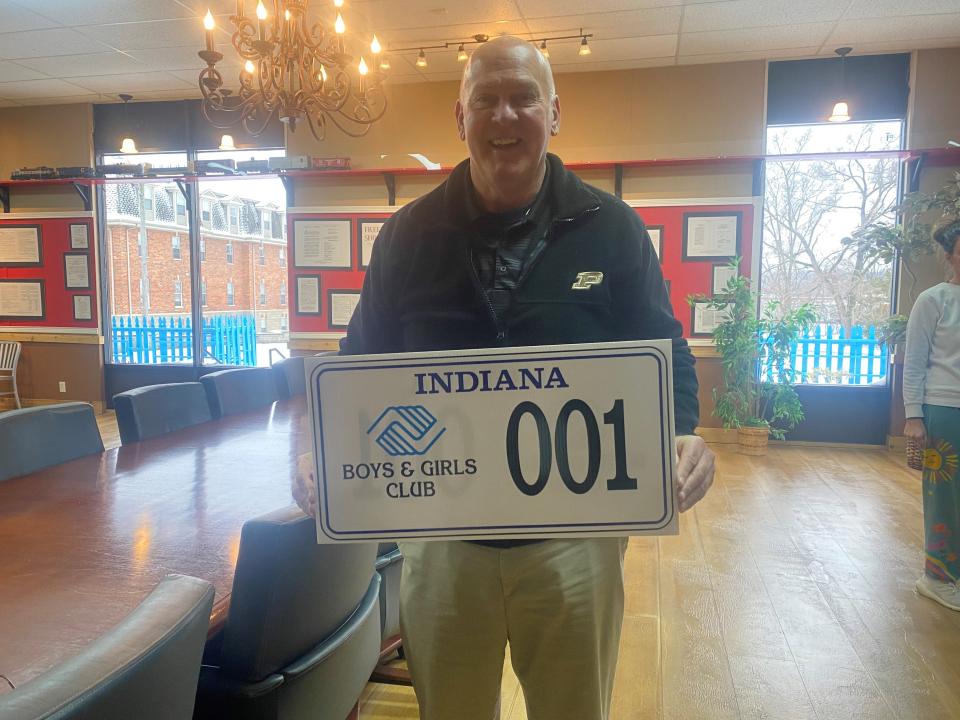 Barry Richard, executive director of the Lyn Treece Boys and Girls Club of Tippecanoe County, holding the model Indiana Boys & Girls Club license plate. Jan. 26, 2023