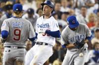 Oct 15, 2017; Los Angeles, CA, USA; Los Angeles Dodgers first baseman Cody Bellinger (35) is safe at first as Chicago Cubs first baseman Anthony Rizzo (44) cannot make a catch in the eighth inning during game two of the 2017 NLCS playoff baseball series at Dodger Stadium. Mandatory Credit: Robert Hanashiro-USA TODAY Sports