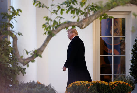 U.S. President Donald Trump walks out of the Oval Office departing on a campaign trip to Wisconsin from the White House in Washington, U.S., October 24, 2018. REUTERS/Cathal McNaughton