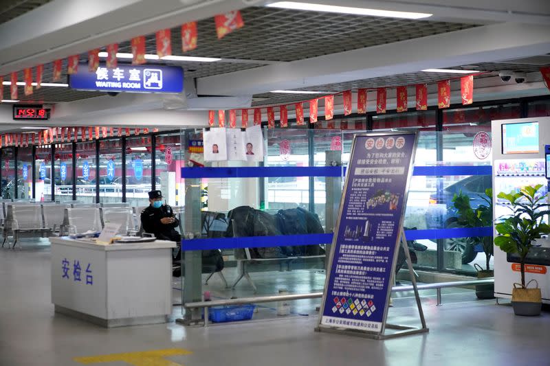 Staff member wears a mask at the closed Pudong International Airport Long Distance Bus Station in Shanghai