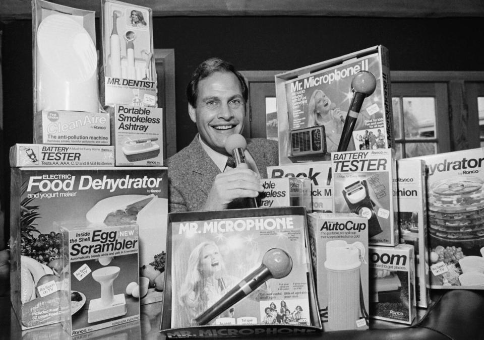 Ron Popeil surrounded by some of his products, including Mr. Microphone, the Egg Scrambler and the Portable Smokeless Ashtray