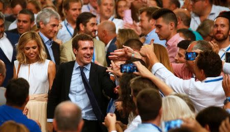 Pablo Casado reacts after being elected as the new leader of Spain's conservative People's Party, and his wife Isabel Torres Orts, in Madrid, Spain, July 21, 2018. REUTERS/Javier Barbancho