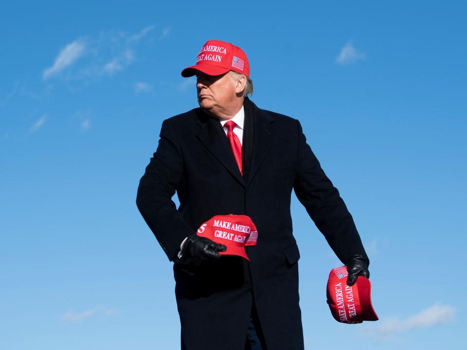 Donald Trump with MAGA hats.