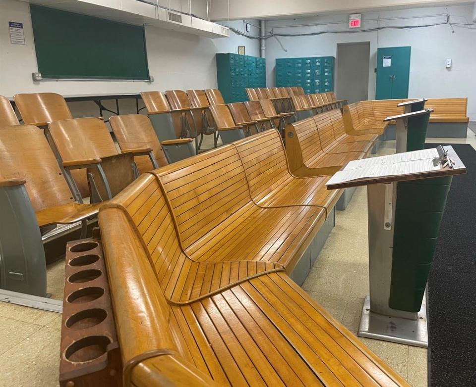 The seating area is an authentic part of the bowling alley, with benches and chairs for players and spectators alike.