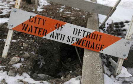 A City of Detroit Water and Sewerage safety barricade covers a hole along Jefferson Avenue in the Delray neighborhood of Detroit, Michigan December 13, 2013. REUTERS/Rebecca Cook