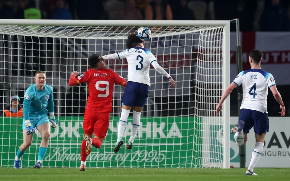 Bojan Miovski of North Macedonia is fouled by Rico Lewis of England