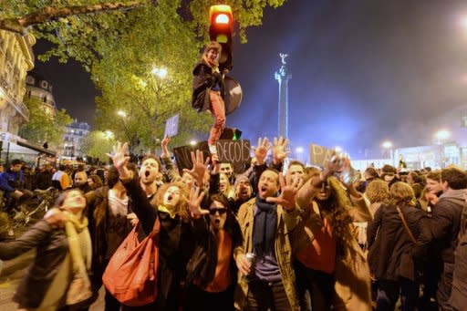 Supporters of France's Socialist Party (PS) newly-elected President Francois Hollande hold signs reading "Don't disappoint us" as they celebrate at the Bastille Square in Paris. Hollande was plunged straight into the European economic debate Monday as doubts over his plans and turmoil in Greece threatened to tip the eurozone back into crisis