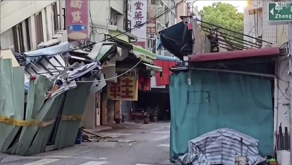 In this image from a video, roads in Hualien, Taiwan are cordoned off after a cluster of earthquakes struck the island early Tuesday, April 23, 2024. There were no reports of casualties in the quakes, although there were further damages to two multi-story buildings that had been evacuated following a magnitude 7.4 quake that hit the island earlier this month, killing 13 people and injuring over 1,000. (TVBS via AP)