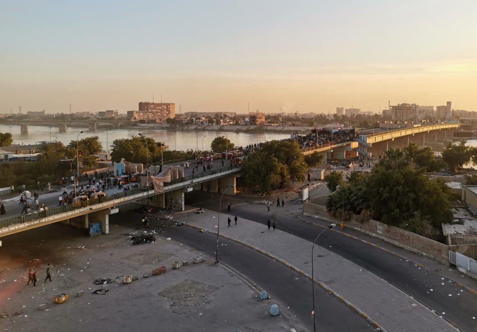 Anti-government protesters gather on the Sinak Bridge leading to the Green Zone government areas, during ongoing protests, in Baghdad, Iraq, Sunday, Nov. 17, 2019. (AP Photo/Hadi Mizban)