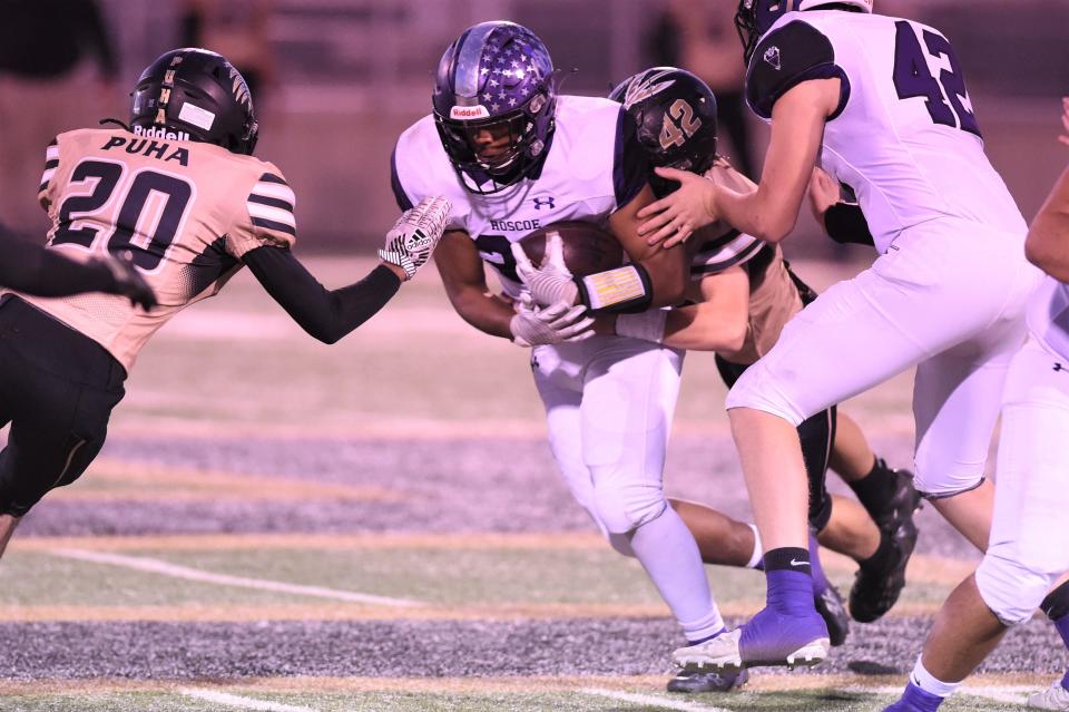 Roscoe's Jake Gonzalez (20) fights for extra yardage during Thursday's Region II-2A Division II bi-district playoff against Quanah at Post on Nov. 11, 2021. The Plowboys pulled away for the 38-16 victory.