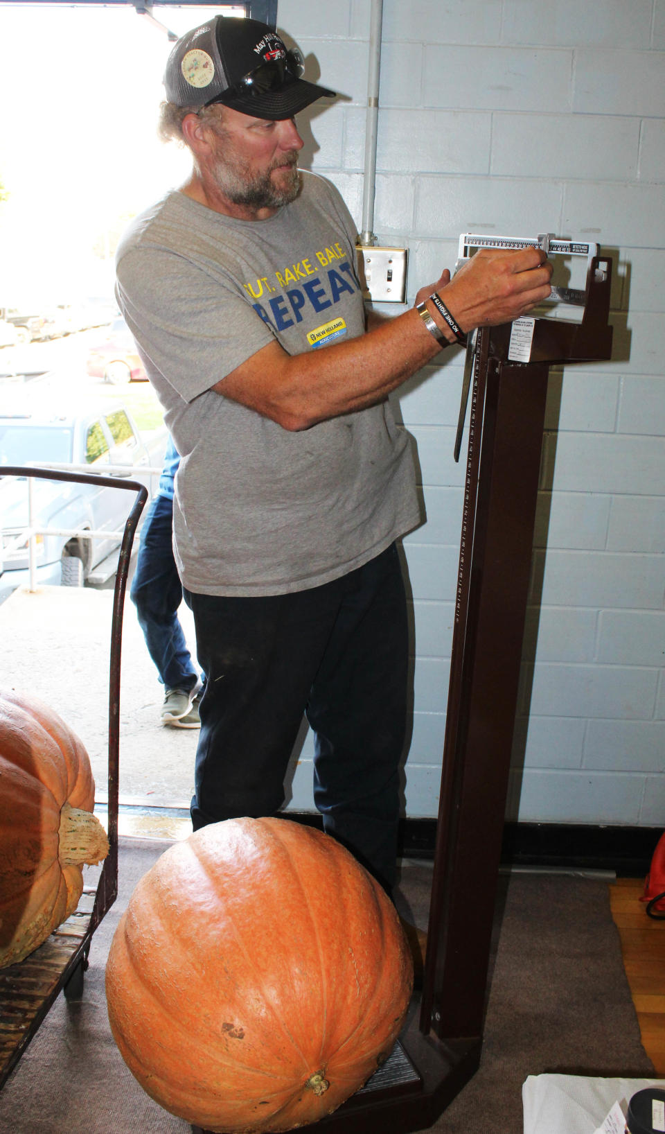 Tim Rhoads, first vice president of the Berlin Fair, weighs in a pumpkin at last year's Berlin Fair.