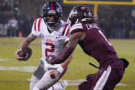 Mississippi quarterback Matt Corral (2) tries to get around Mississippi State cornerback Martin Emerson (1) during the first half of an NCAA college football game, Thursday, Nov. 25, 2021, in Starkville, Miss. (AP Photo/Rogelio V. Solis)